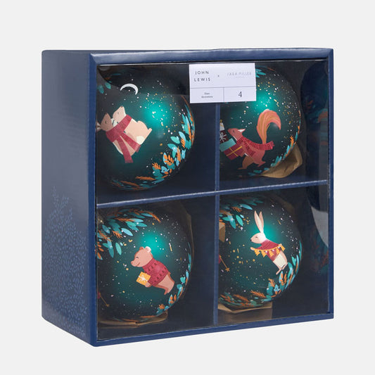 Set of four decorative green ornaments in a blue box with branding.