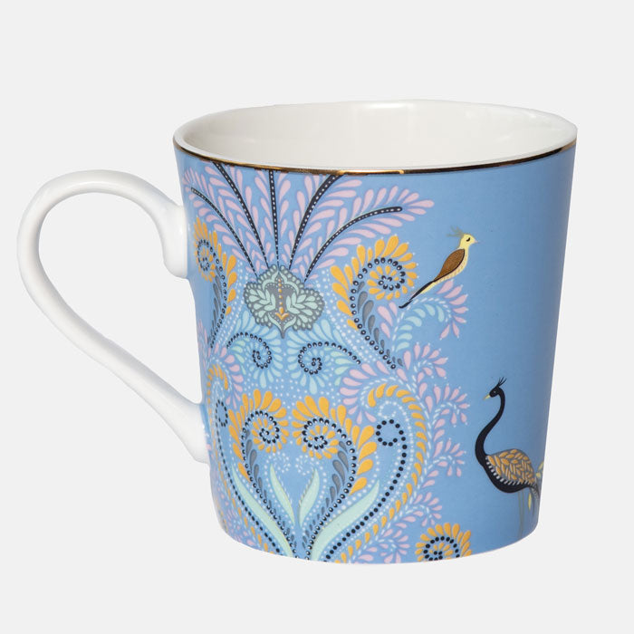 Peacock mug on white background. Blue mug with filigree design.