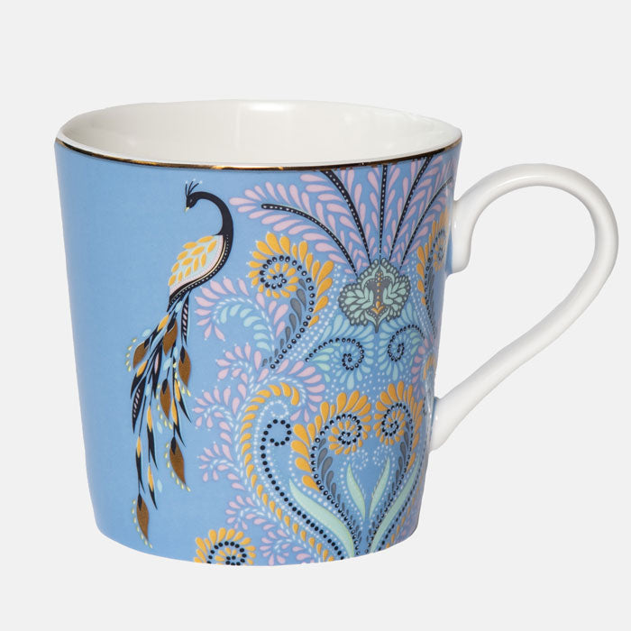 Peacock mug on white background. Blue mug with filigree design.