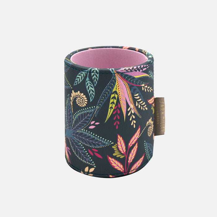 Floral patterned pen holder with pink interior on a blue background