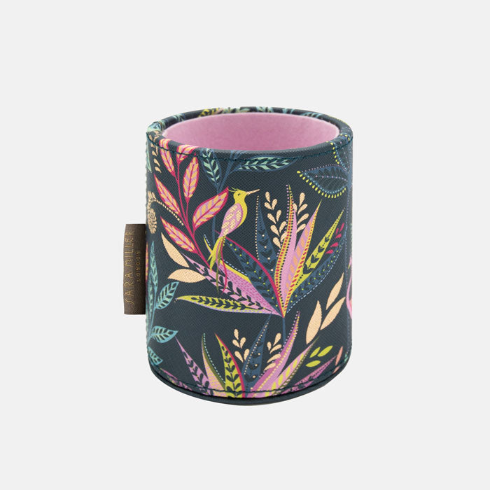 Colourful cylindrical container with floral and bird pattern on a blue background