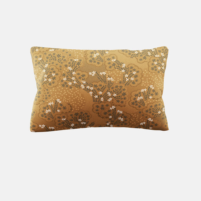 Decorative pillow with floral pattern on a yellow ochre background