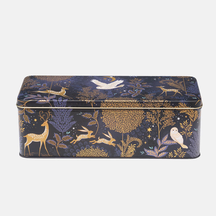 Decorative tin box with moonlit forest design on a white background