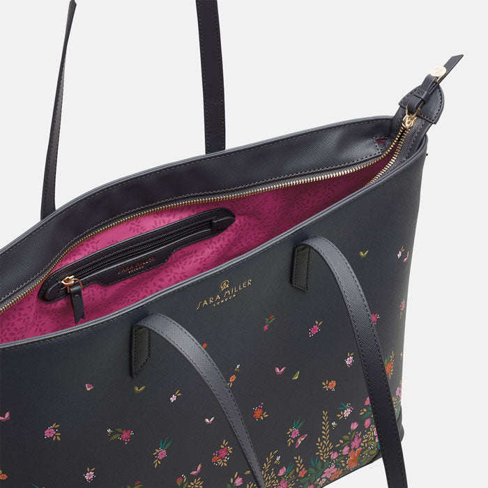 Ditsy floral large tote bag, long straps, deep navy blue colour. Can see inside pink lining.