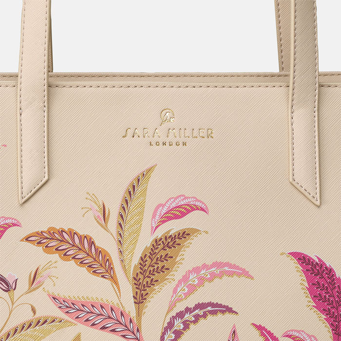 Close up of Sara Miller London gold embossed logo, can see bag texture.