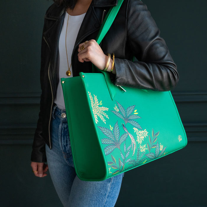 Green Boxy Tote bag worn by model, moody background colours.