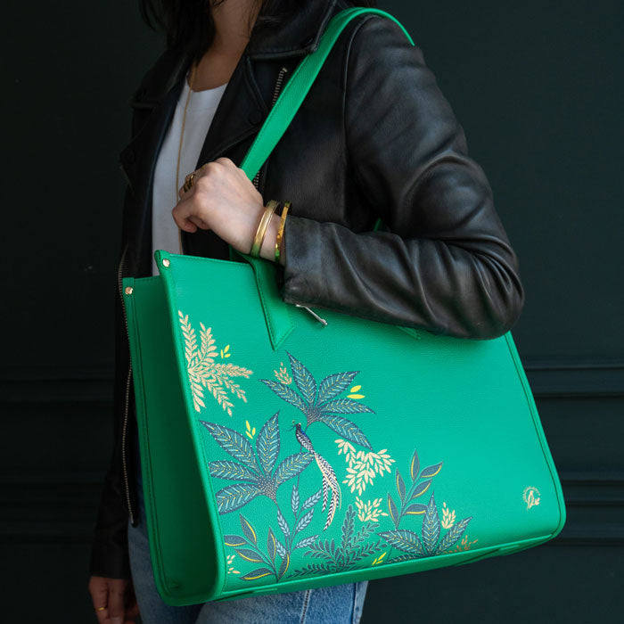 Green Boxy Tote bag worn by model, moody background colours.