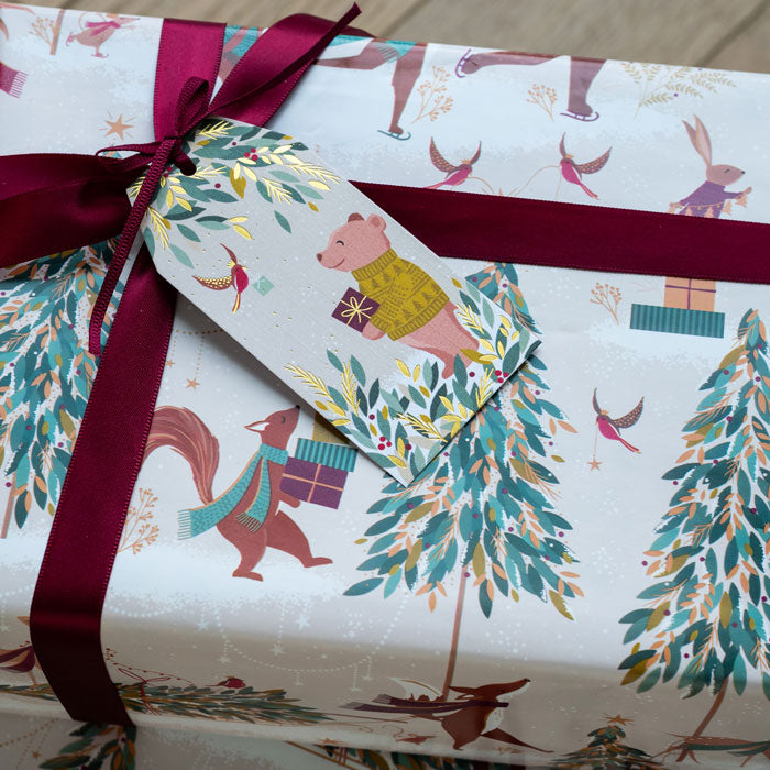 Gift tag with a ribbon, featuring animals and nature-themed design.
