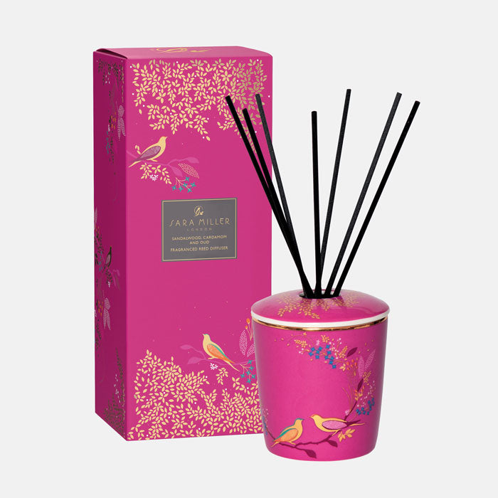 Pink diffuser with lid and black reeds, matching packaging box.
