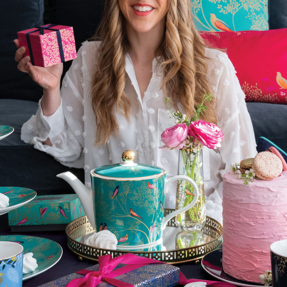 Green teapot shown with model, and other similar gifts with wrapping.