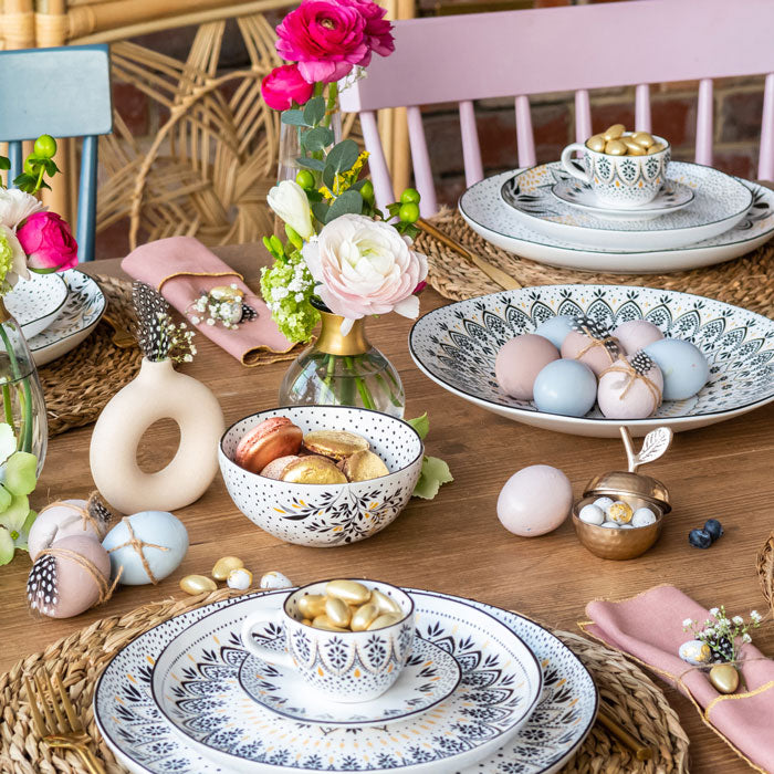 Matching black and white gold embellished serveware from the collection in an Easter themed table setting.