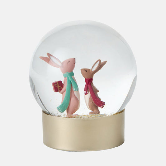 Snow globe with two rabbits wearing scarves on a white background