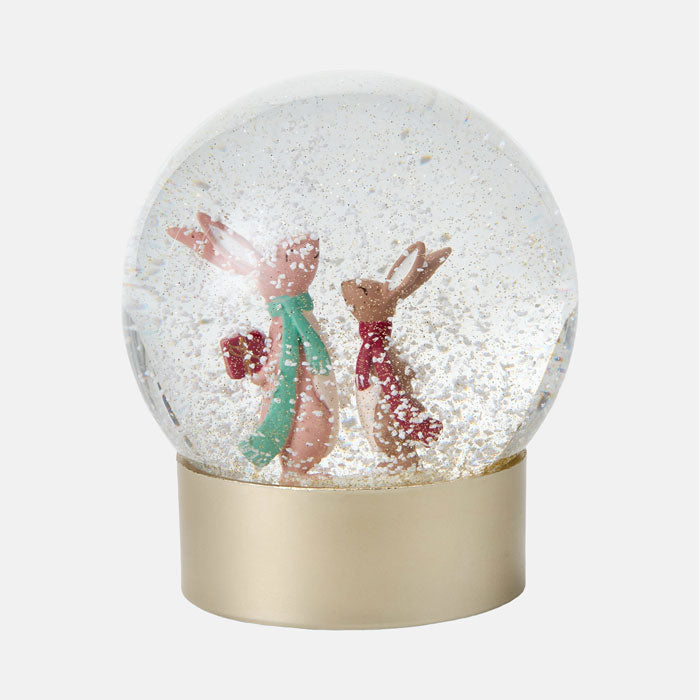 Snow globe with two rabbits on a white background