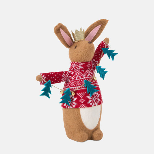 Felt rabbit figurine wearing a red sweater with Christmas tree lanyard decorations on a white background