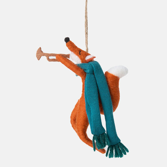 Decorative fox ornament with a blue scarf and trumpet on a white background