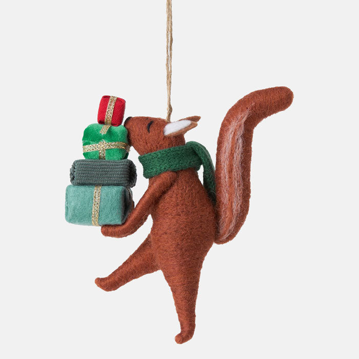 Felt squirrel ornament with presents on a white background