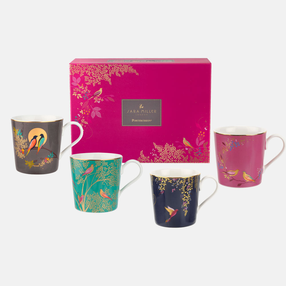 Four mugs placed around pink and gold embellished packaging box.