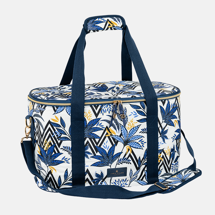 Floral patterned bag with blue straps on a white background