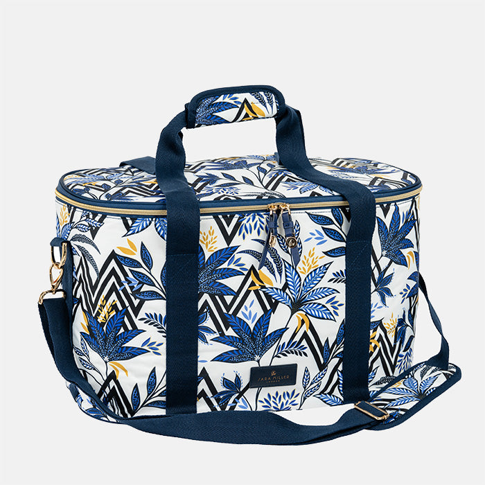 Patterned cooler bag with blue straps on a white background