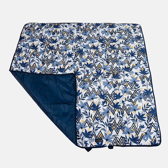 Floral and geometric patterned picnic blanket on a white background
