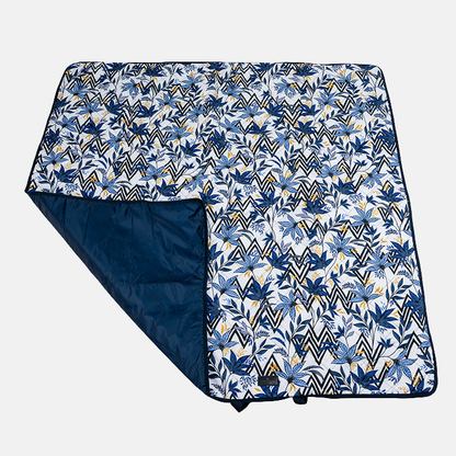 Floral and geometric patterned picnic blanket on a white background