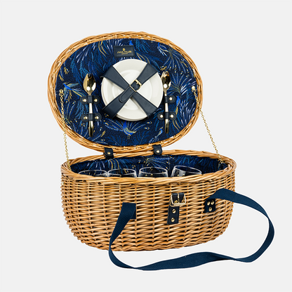 Open picnic basket with blue interior, cutlery, and glasses on a white background