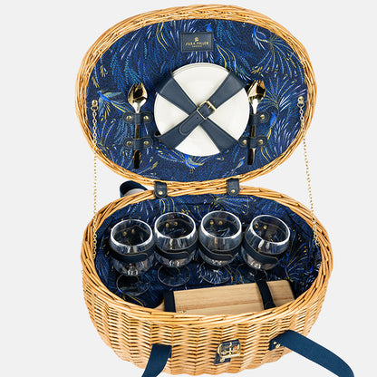 Open picnic basket with blue interior, cutlery, plates, and glasses on a white background