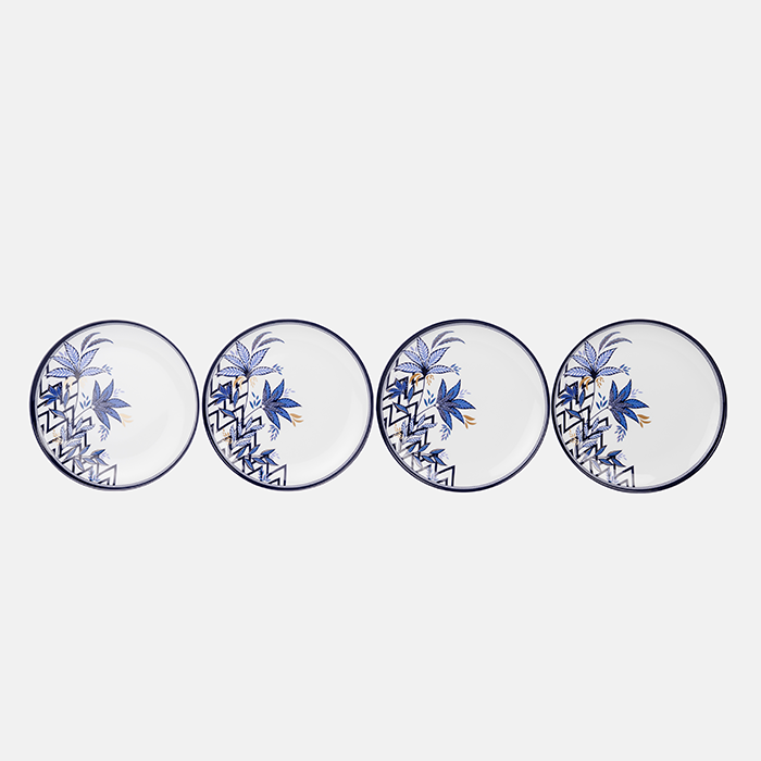 Four plastic plates with blue floral and geometric patterns on a white background