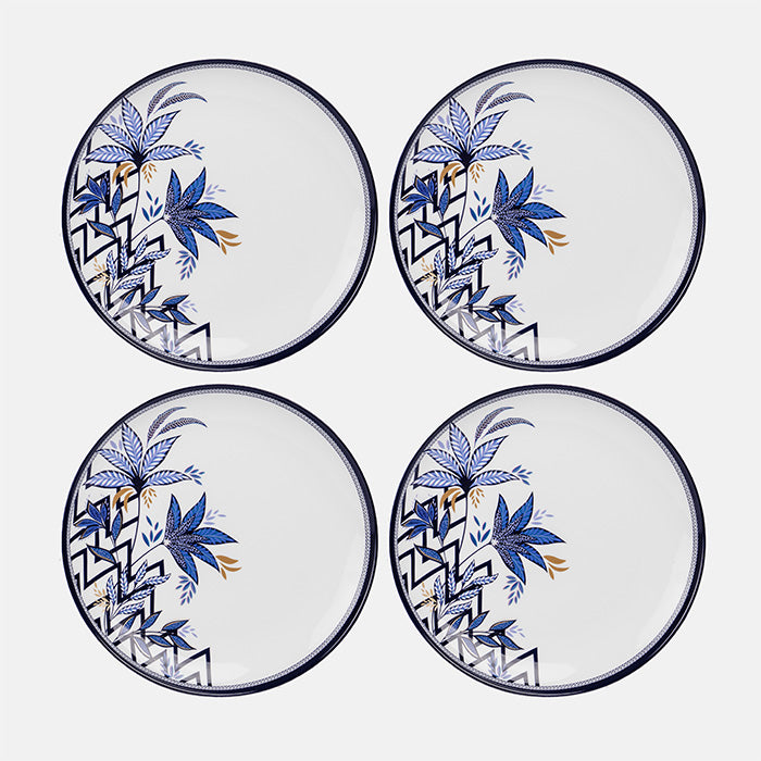 Four plastic plates with blue floral and geometric patterns on a white background