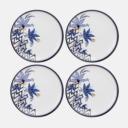 Four plastic plates with blue floral and geometric patterns on a white background