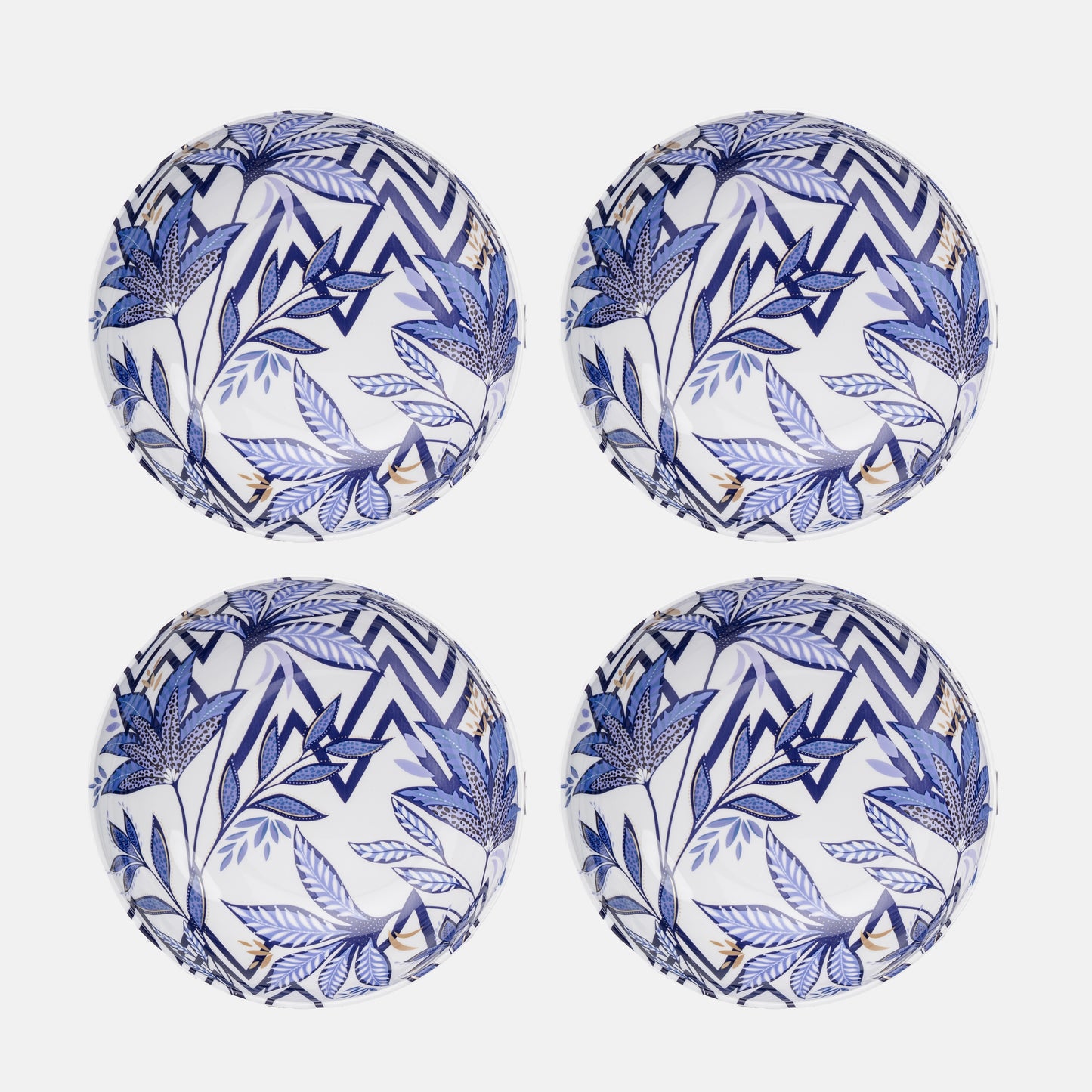 Four blue and white patterned plastic plates on a white background