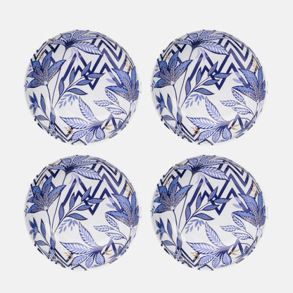 Four blue and white patterned plastic plates on a white background