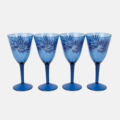 Set of four blue plastic wine glasses with decorative patterns on a white background