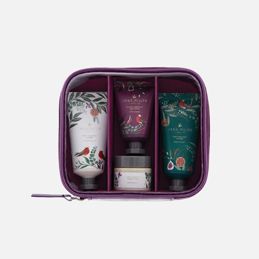 A clear beauty pouch filled with mini cosmetic items with festive packaging.