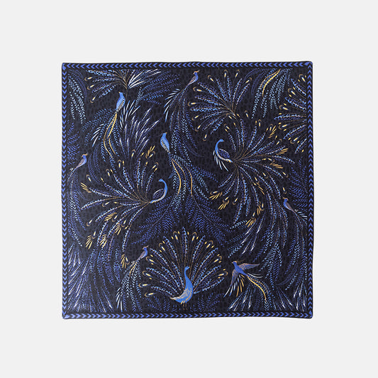 Blue napkin with peacock design and chevron edging.