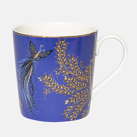 Blue mug with gold leaf and butterfly design on a white background
