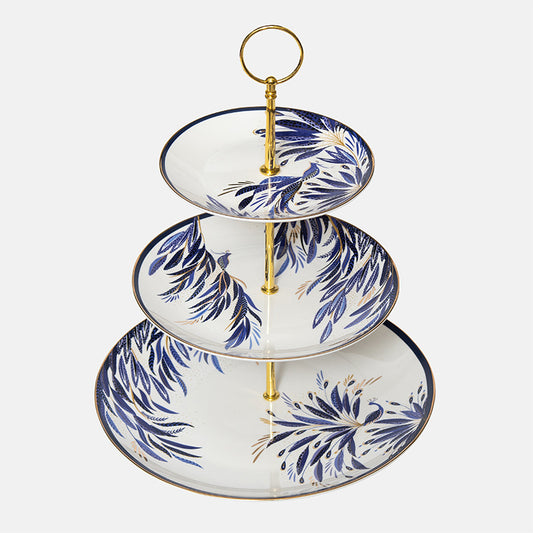 Three-tiered ceramic stand with blue peacock design on a white background