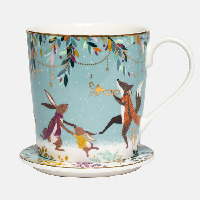 A green fine china mug with a matching coaster, decorated with a whimsical winter scene featuring rabbits, a fox, and hanging leaves on a light green background.