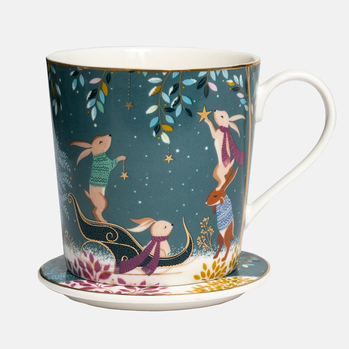 A fine china mug and matching coaster featuring a whimsical winter woodland illustration with rabbits under a starry night sky.