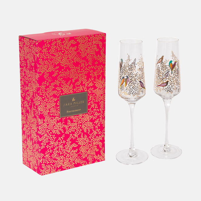 Two decorated champagne flutes with a matching pink box featuring a floral pattern and 'Sara Miller' branding.