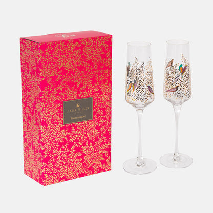 Two decorated champagne flutes with a matching pink box featuring a floral pattern and 'Sara Miller' branding.