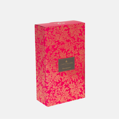 Pink floral-patterned box with a brand label on a white background
