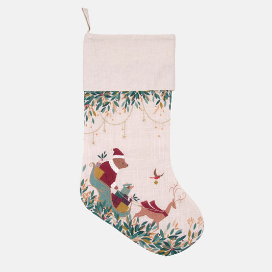 Christmas stocking with festive bear in sleigh and foliage design on a cream background
