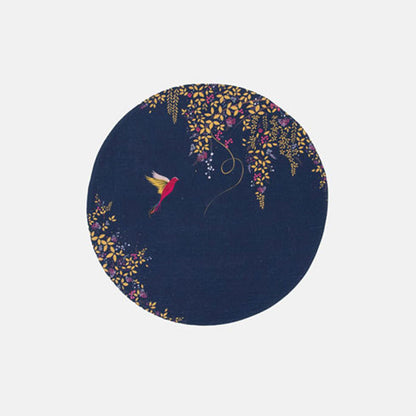 A round navy blue fabric placemat with a hummingbird and foliage design.