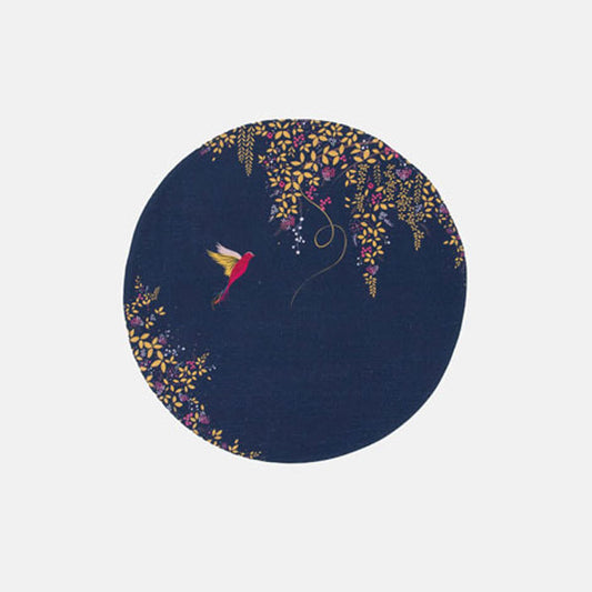 A round navy blue fabric placemat with a hummingbird and foliage design.