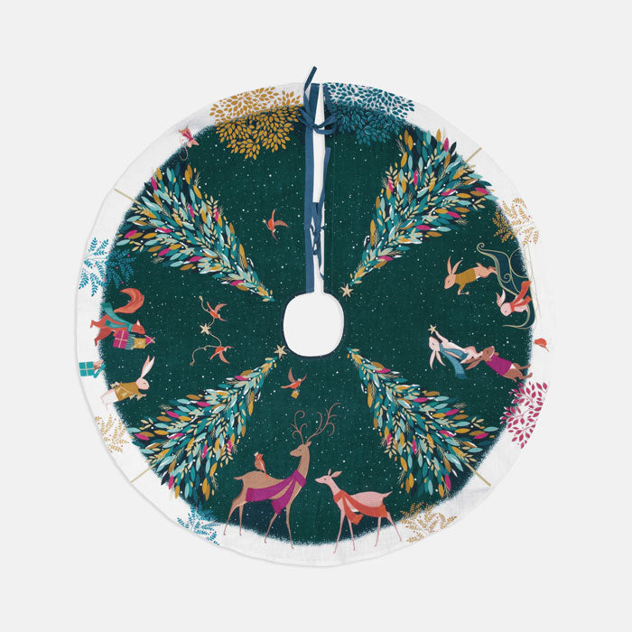Decorative festive tree skirt with Christmas trees, woodland animals in a festive forest scene on a dark green background.