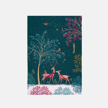 Festive tea towel with deer, robin and tree design on a dark blue background