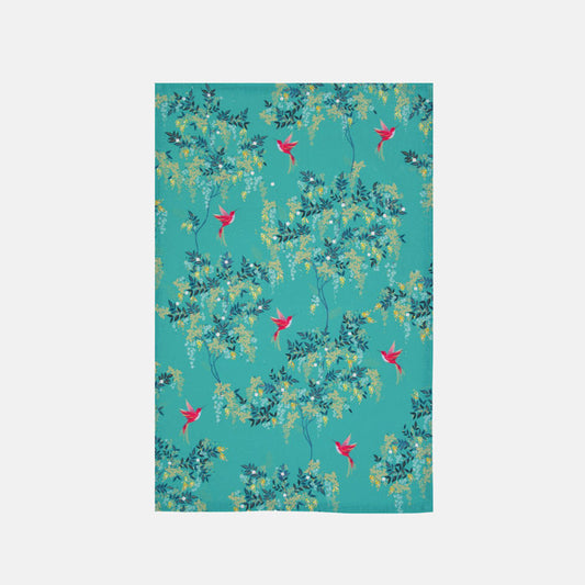 Green fabric placemat with floral and hummingbird pattern