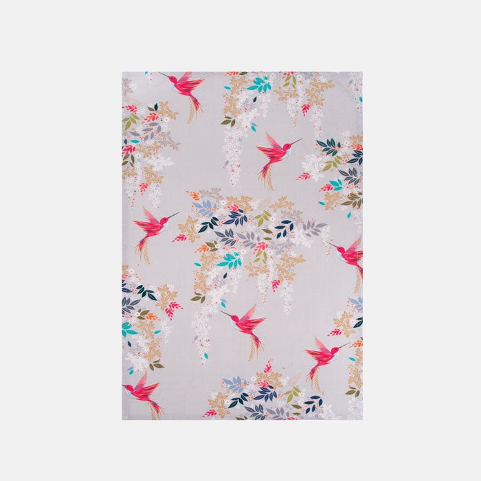 Fabric tea towel with pink hummingbird and foliage design on a grey background