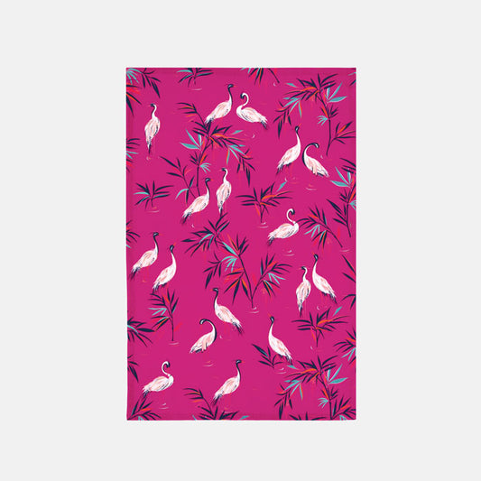 Fabric placemat with white heron birds and bamboo foliage on a bright pink background